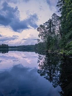 Images Dated 8th August 2019: Scenic summer night landscape with mood light and beautiful reflections at lakeside in Finland