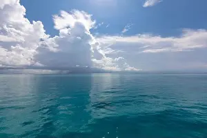 Scenic summer view of the blue tropical sea or ocean resort and sky with clouds. Beautiful ocean beach