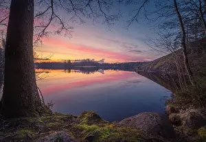Scenic sunset landscape with peaceful lake and beautiful colors at summer evening in Finland