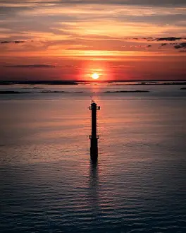Gulf Of Finland Prints: Scenic sunset landscape with sea and lighthouse at evening in Finland