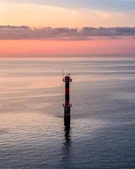 Scenic sunset landscape with sea and lighthouse at evening in Finland