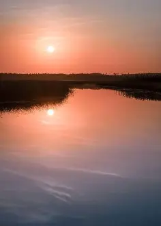 Orange Tree Prints: Scenic sunset landscape with water reflections and mood colors at autumn evening in Finland