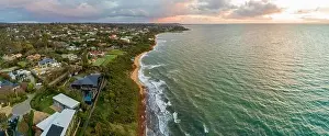 Coastlline Prints: Scenic sunset over ocean coastline with luxury real estate homes and beautiful water at sunset