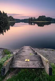 Scenic tranquil landscape with wooden stairs and sunset at autumn evening in Finland