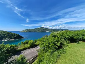 Sky Travel Prints: Scenic tropical coastline with green hills blue sea and clear sky