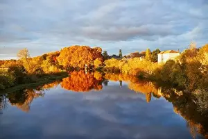 Scenic view of autumn forest and river Vienne near medieval castle of Les Ormes, France
