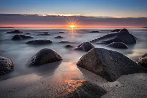 Beam Of Light Prints: Scenic view from beach with stones and sunset at summer night in Lofoten, Norway