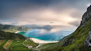 Scenic view from beach with turquoise water and mountains at beautiful summer day in Kvalvika beach, Lofoten, Norway
