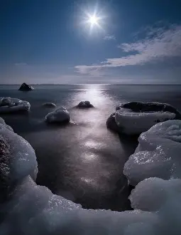 Scenic view with moonlight and icy sea at winter night in coastline, Finland