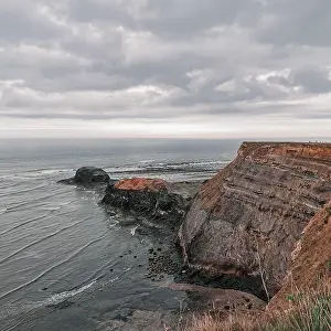 Dreamy Prints: A scenic view of a picturesque sea surrounded by large rocky formations on a cloudy day