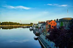Landscape Architecture Prints: Scenic view of the River Corrib with colorful buildings and a stone fort in Galway