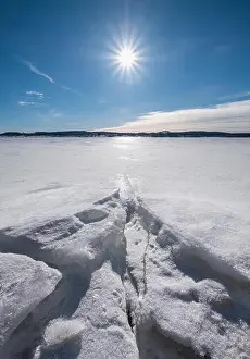 Beams Prints: Scenic winter landscape with bright sunlight and sun at winter day in lake Finland