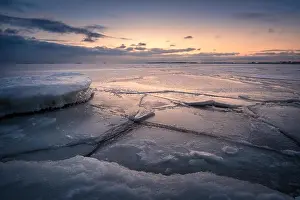 Scenic winter landscape with frosty sea and sunset at evening in Helsinki, Finland