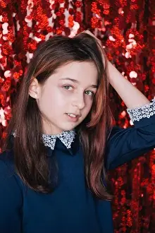 Schoolchild Prints: school girl. Schoolgirl on a red background portrait