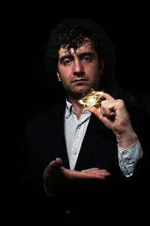 Nuclear Prints: Scientist man holding atom particle between his fingers