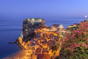Scilla, Italy on the Mediterranean coast at twilight with seasonal flowers