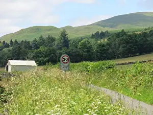 Staycation Prints: Scottish scenery at its best: the Ochil Hills in Clackmannanshire with a 30 mph sign on a small country road