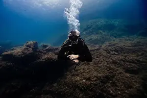 Wildlife Observation Prints: A scuba diver, unrecognizable due to his gear