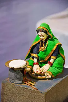 Preparing Food Prints: Sculpture of traditional Maharashtrian woman making rotis on a traditional oven or chulla