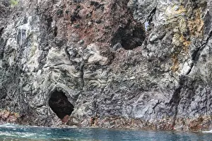 Geologic Prints: Sea caves eroded into the volcanic shoreline of Santiago Island in the Galapagos Islands of Ecuador