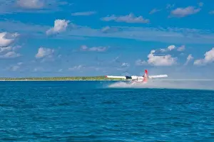 Sea plane at tropical beach resort. Luxury summer travel destination with seaplane in Maldives islands. Exotic vacation or holiday transportation