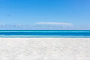 Sand Island Prints: Sea sand sky concept. Closeup of sand on beach and blue summer sky