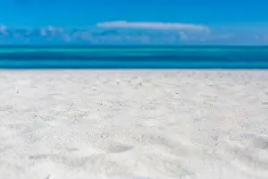 Sea sand sky concept. Closeup of sand on beach and blue summer sky, calmness and inspiration nature concept