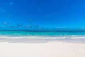 Sea sand sky concept. Closeup of sand on beach and blue summer sky, calmness and inspiration nature concept