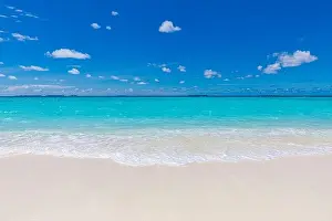Sea sand sky concept. Closeup of sand on beach and blue summer sky, calmness and inspiration nature concept. Summer seascape beautiful waves, blue sea