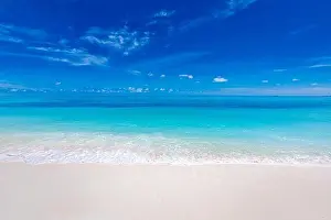 Sea sand sky concept. Tropical island paradise, beach view with endless sea horizon. Tranquil relaxing peaceful nature landscape, waves splashing surf