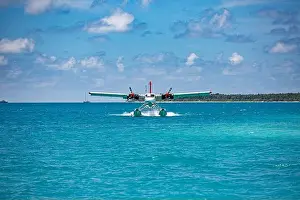 Seaplane at tropical beach resort. Luxury summer travel destination with seaplane in Maldives islands. Exotic vacation holiday transportation Maldives
