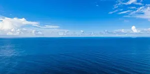 Seascape with sea horizon and almost clear deep blue sky background. Perfect sky and water, endless ocean view, blue color. Soft waves, surf concept