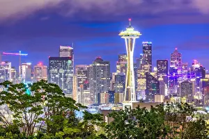 Seattle, Washington, USA downtown skyline at night with Mt. Rainier