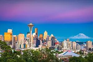 Seattle, Washington, USA downtown skyline at night with Mt. Rainier