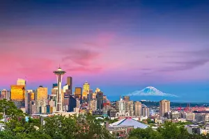 Seattle, Washington, USA downtown skyline at night with Mt. Rainier