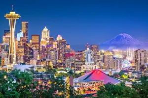 Seattle, Washington, USA downtown skyline at night with Mt. Rainier