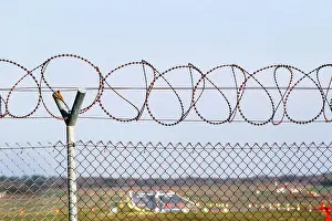 Forbidden Prints: Security Fence. Protective wire barbed fence at the airport
