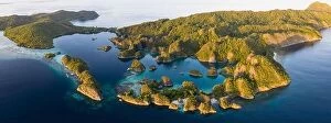 Aerial Landscape Collection: Seen from an aerial view, the tropical Pacific Ocean surrounds the rugged limestone islands