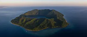 Seen from a bird's eye view, the blue Pacific Ocean surrounds the scenic volcano of Satonda, just north of Sumbawa in Indonesia