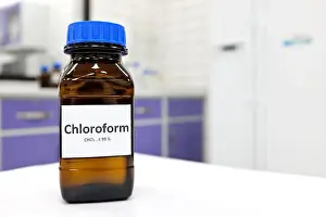 Concentrated Prints: Selective focus of chloroform or trichloromethane liquid chemical in glass amber bottle inside a chemistry laboratory