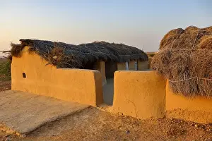 Thatched Roof Prints: A selective focus image of a mud house with thatched roof in an village in Rajasthan India