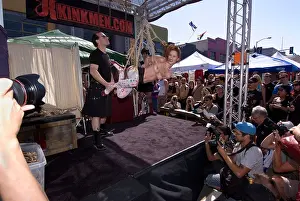 Semi-Naked woman suspended in bondage on a stage at the 2008 Folsom Street Fair in San Francisco, CA