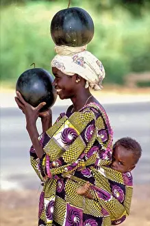 Senegal Prints: Senegal, Woman has bought fresh watermelons on the market