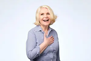 Maturity Prints: Senior caucasian woman with blonde hair in blue shirt smiling posing at studio