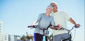 Adoring Prints: Senior couple with bicycles on beach