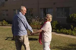 Senior Citizen Prints: Senior couple holding hands in the park