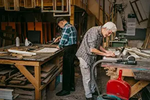 Art And Craft Prints: Senior craftsmen working together at carpentry workshop