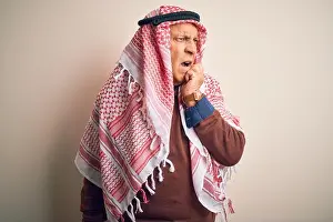 Panic Prints: Senior handsome arab man wearing keffiyeh standing over isolated white background looking stressed