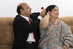 Saree Prints: Senior man tucking rose in the hair of his wife