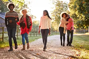 Offspring Prints: Senior Parents With Adult Offspring Enjoying Autumn Walk In Countryside Together
